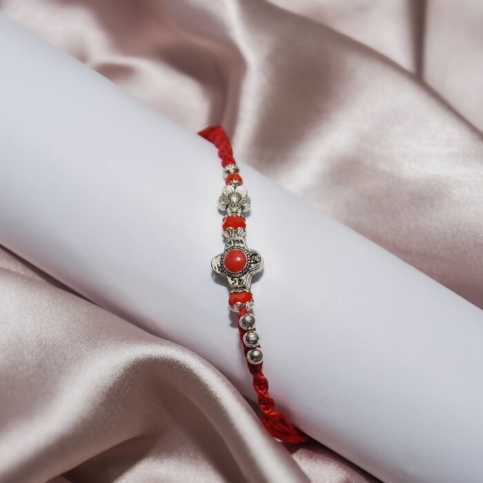 Metal Flower with Red Pearl - Designer Rakhi - Image 1